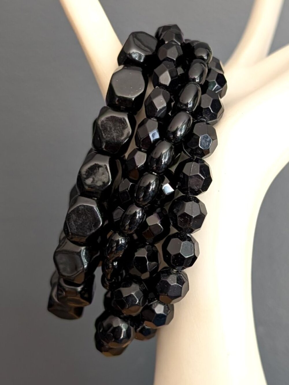 Bundle of black beaded stretch layering bracelets